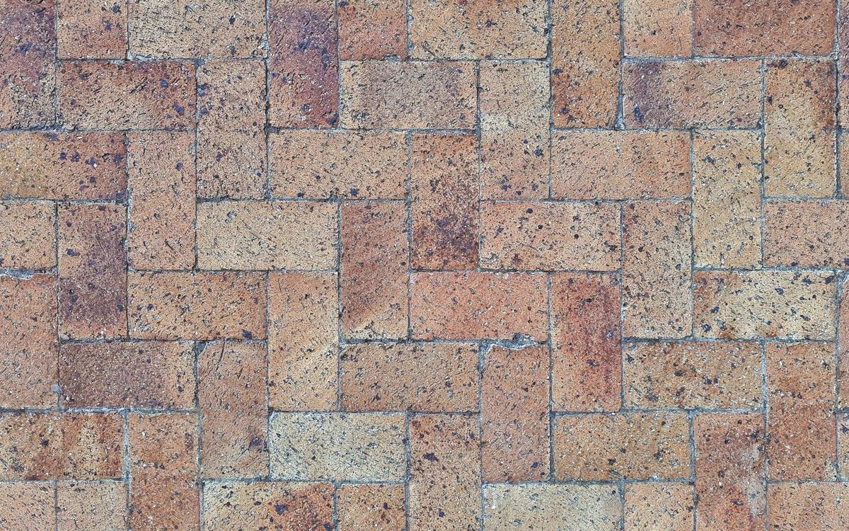 Freshly cleaned herringbone block paving driveway