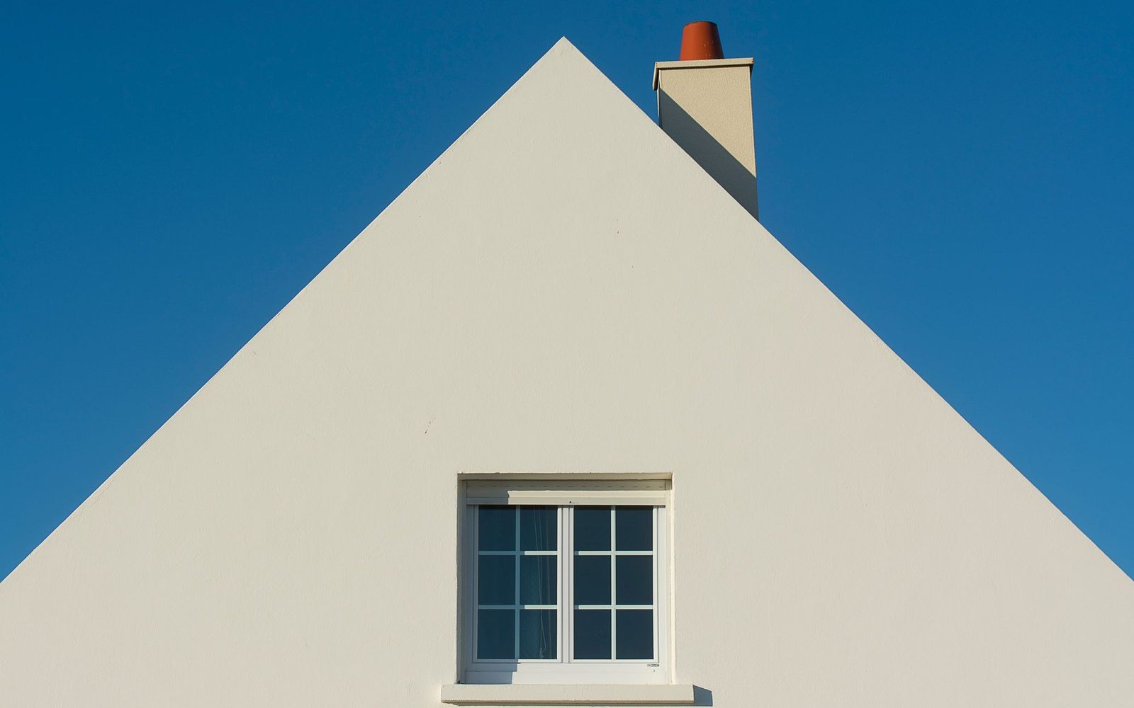 Freshly cleaned white render on a house gable end